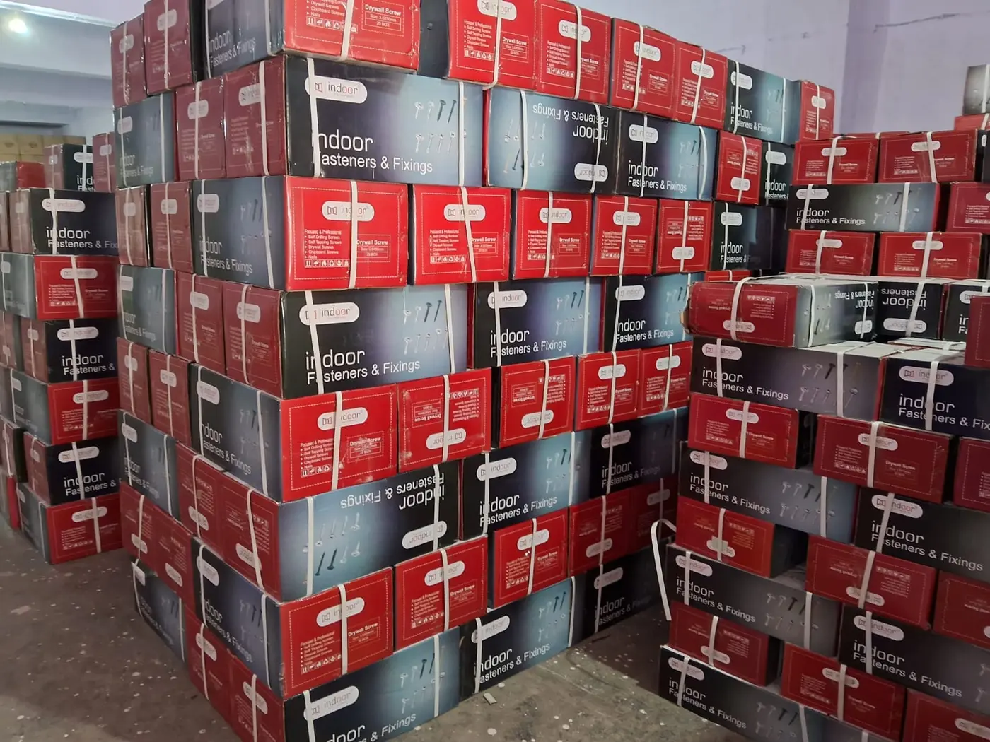 Bulk drywall screw cartons on the floor of the Modern Fastening Solution godown