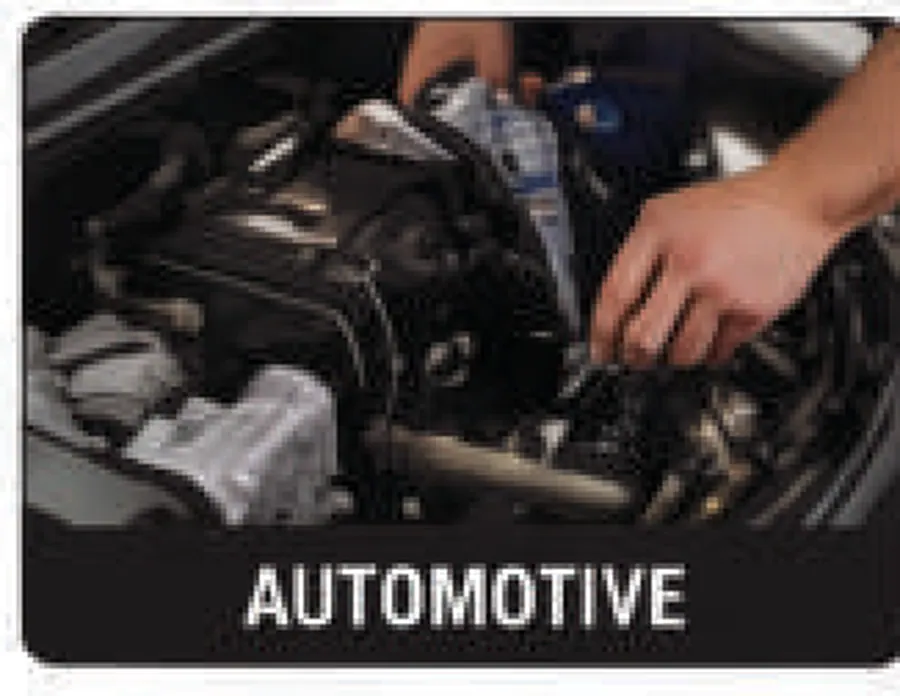 Mechanic working under the bonnet in a vehicle workshop